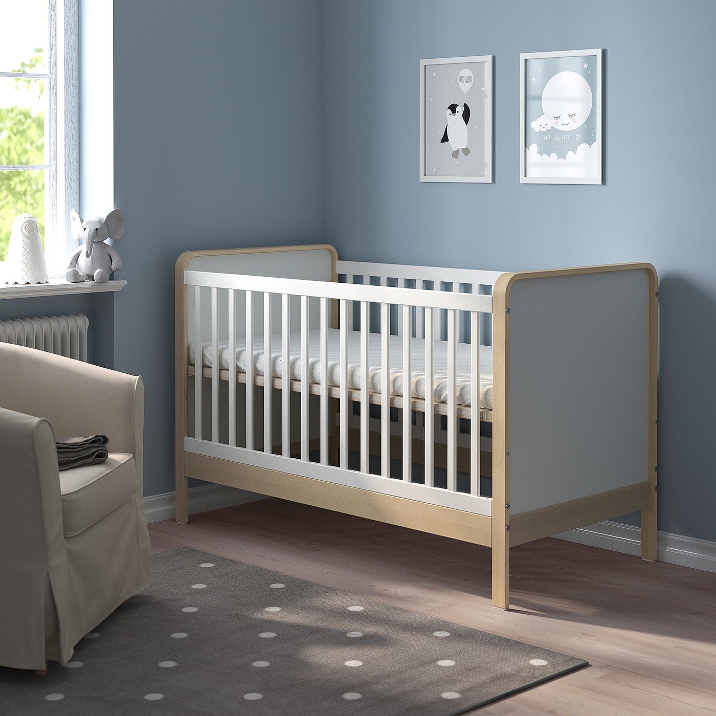 Blue kids room, grey cot, art prints.