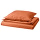 An ÄNGSLILJA orange bedding set, neatly folded. It includes a duvet cover and pillowcases made of soft, pre-washed cotton in a warm, earthy shade.