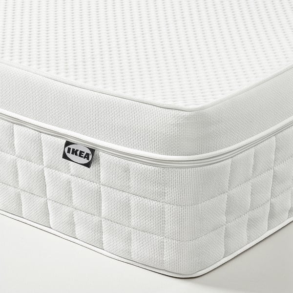 Close-up of ÅVABERG mattress, showcasing soft textures and ikea branding in corner.