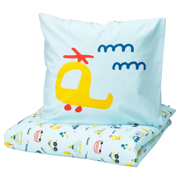 Kids pillow & sheet set named BARNDRÖM. Pillow has a yellow bus, sheet shows colourful vehicles. 100% cotton.