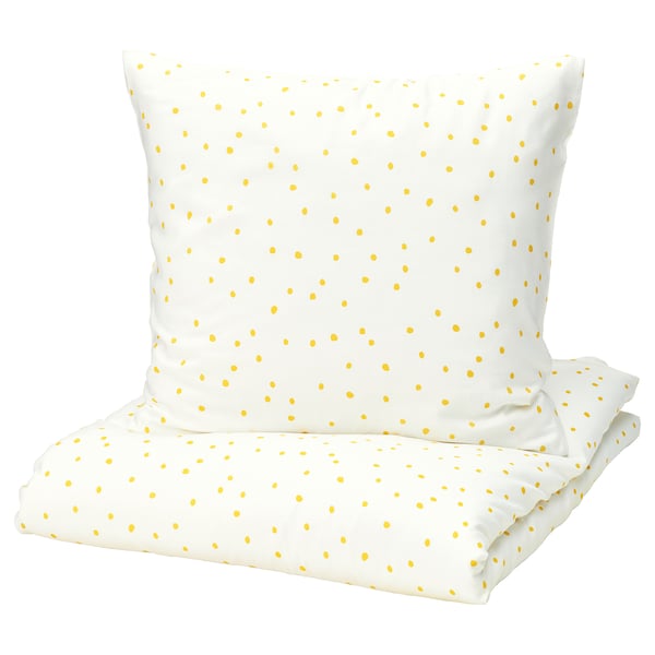 A white BARNDRÖM bedding set with yellow polka dots, featuring a pillowcase and sheet.