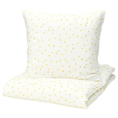 A white BARNDRÖM bedding set with yellow polka dots, featuring a pillowcase and sheet.