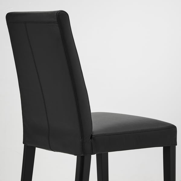 Black leather chair with a high back, sleek design, and sturdy legs. Provides cushioned comfort and lumbar support.