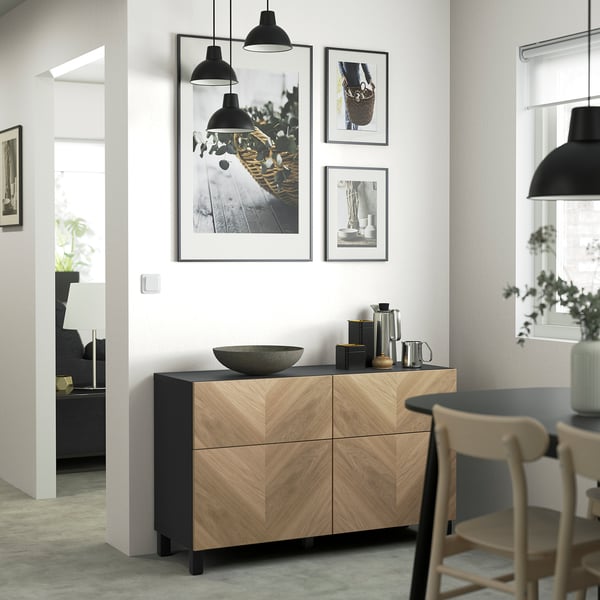 Modern living room with BESTÅ sideboard, lamps, photos, decor. Dining area on right.