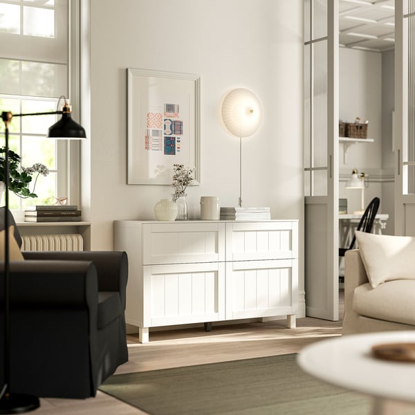 Modern living room with BESTÅ sideboard, chair, sofa, and decor.
