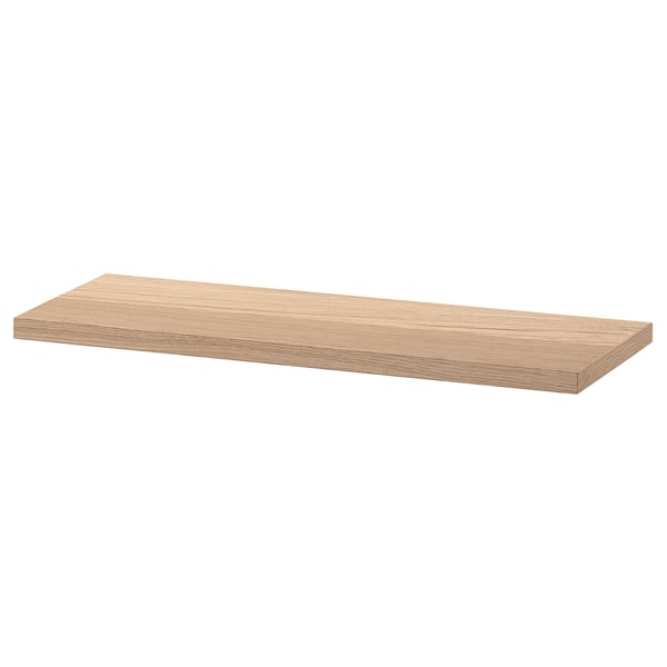 An ikea BESTÅ wooden shelf with a smooth, light oak finish. Its rectangular shape is perfect for storage and display.