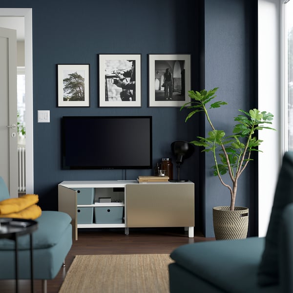 Modern living room a BESTÅ tv unit with cabinets, a flat-screen tv, and decorations. The tv bench keeps cables organised.