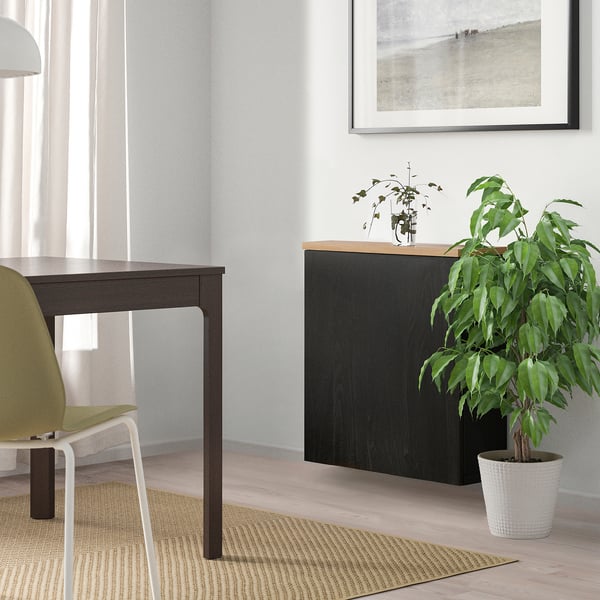 Modern minimalist room with BESTÅ storage, plant, and art.