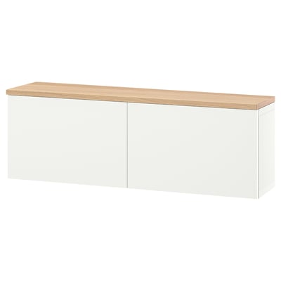 A white BESTÅ storage unit with an oak top, featuring two closed sections. Modern, wall-mounted, with adjustable shelves inside.