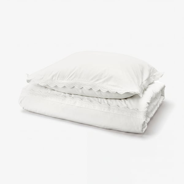 White folded duvet cover with lace trim, 100% cotton.