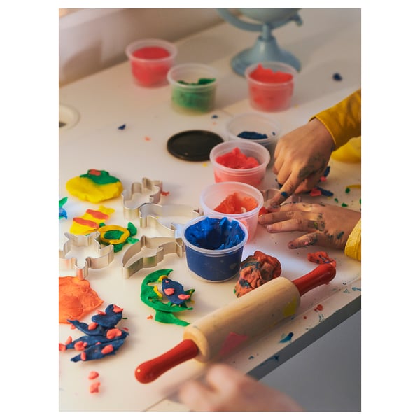 Children playing with colorful dough and shaped cutters.