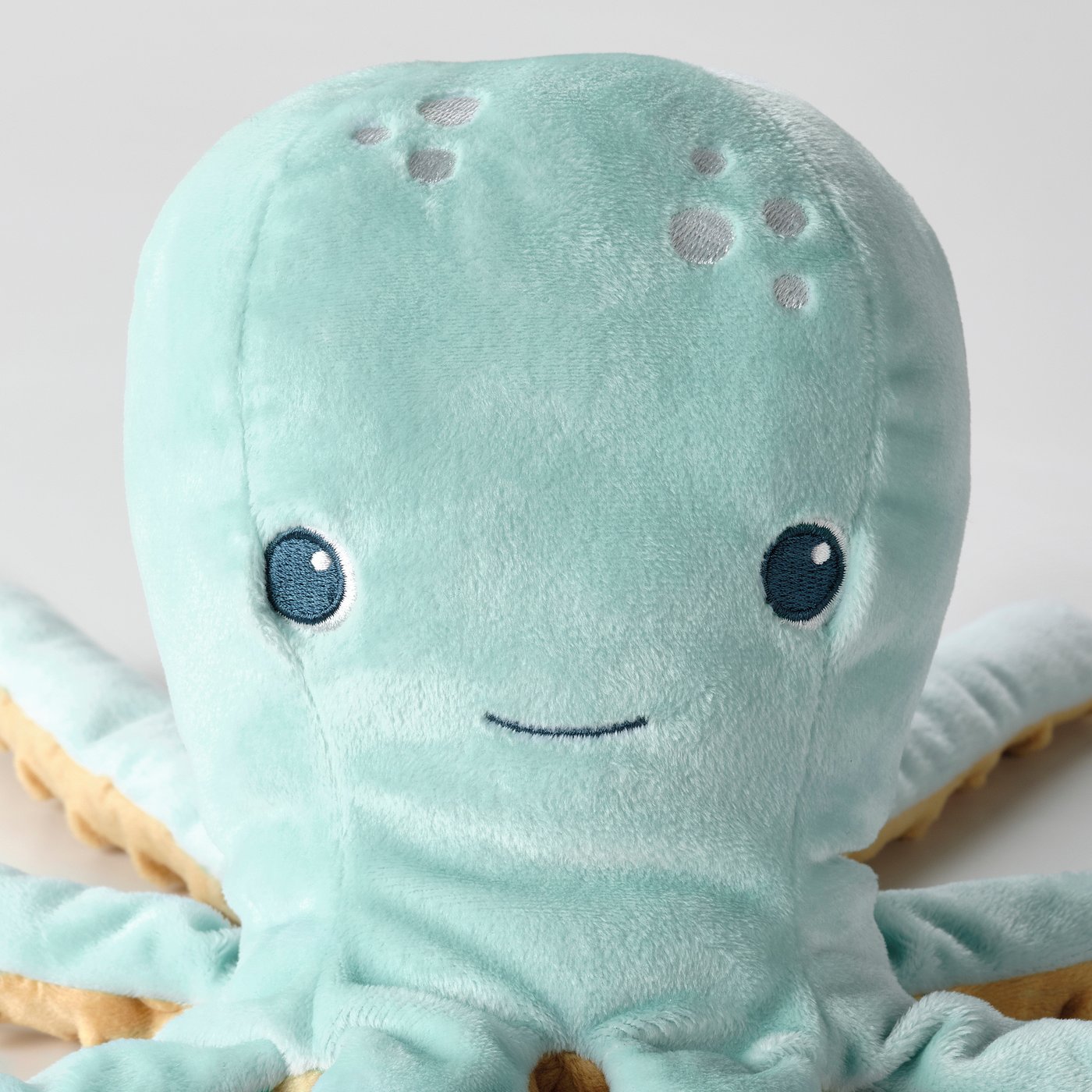 Soft plush octopus toy with gentle, glowing eyes, perfect for children. Made from recycled materials.