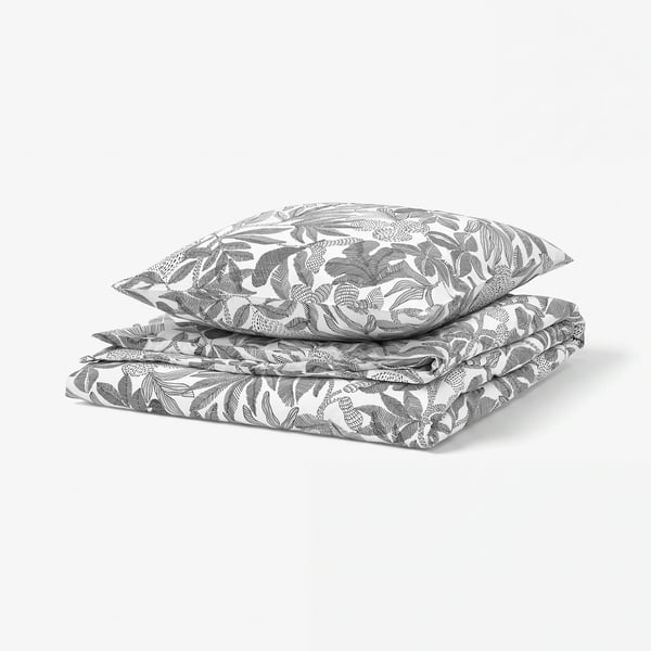 Black and white bed linens with floral pattern.