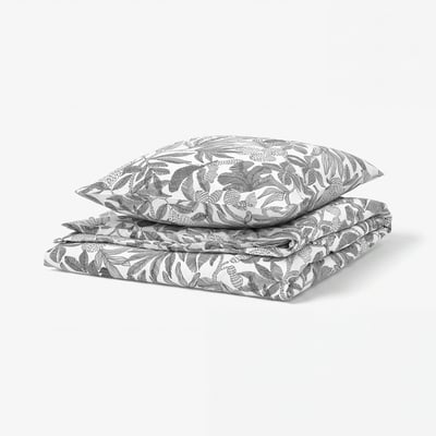 Black and white bed linens with floral pattern.