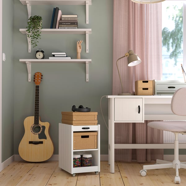 Home office with BRYTNING desk, guitar, and window view.