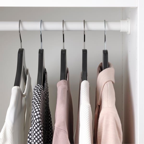 Closet shelf with hooks holding sweaters, prevents clothes from sliding.