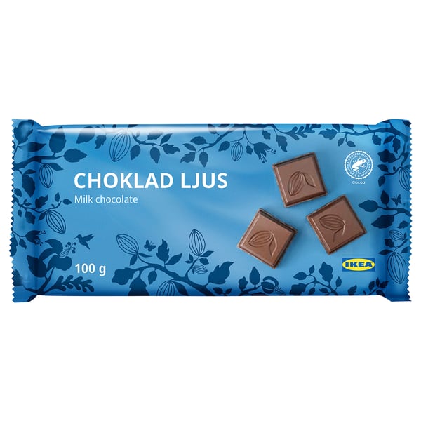 IKEA milk chocolate bar packaging. Blue wrapper with cocoa beans design and three small chocolate pieces.