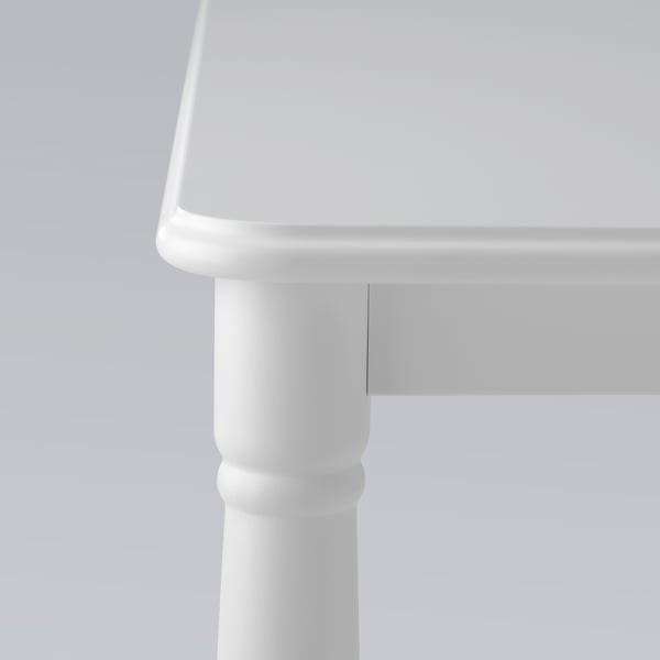 Close-up of a modern, white table leg. Smooth, sturdy finish; part of DANDERYD dining set.