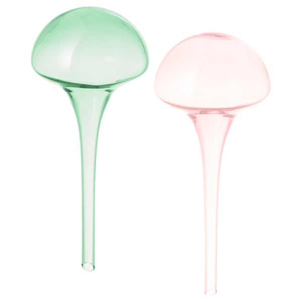Two colourful, mouth-blown glass self-watering plant inserts; one green, one pink, both with a round top and narrow base.