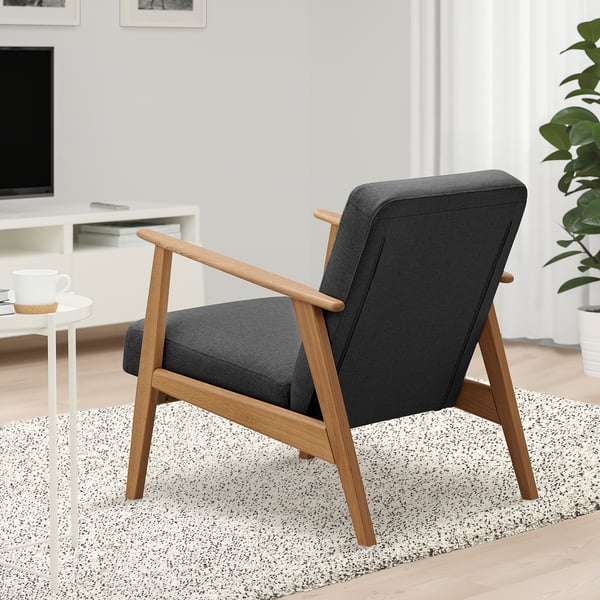 EKENÄSET chair: dark grey, wooden legs, retro design, mid-century shape, comfortable seat, large for room.