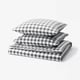 Elegant chequered duvet and pillow set in grey and white, crafted from soft organic cotton.