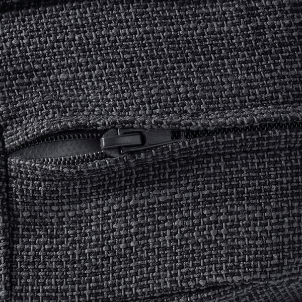 Close-up of durable, textured fabric with smooth zip, showing quality stitching and detail.