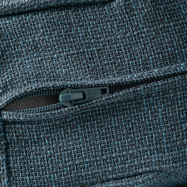 Closed zip on textured, woven fabric, likely from a removable sofa cover.