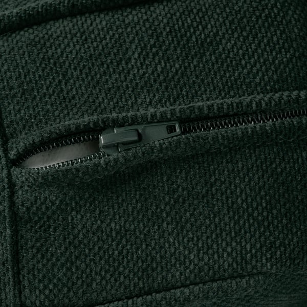 A dark green fabric close-up, showcasing a durable zip and textured material.