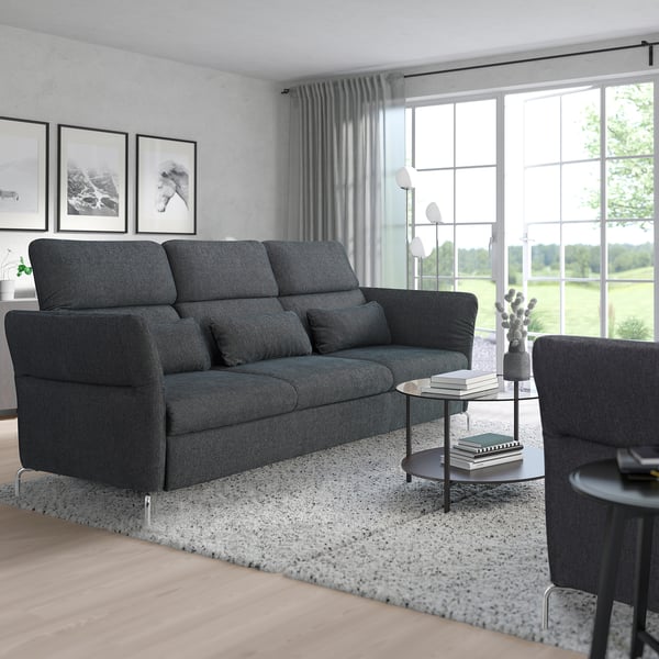 Modern living room with grey FAMMARP sectional, large windows, and cosy decor.