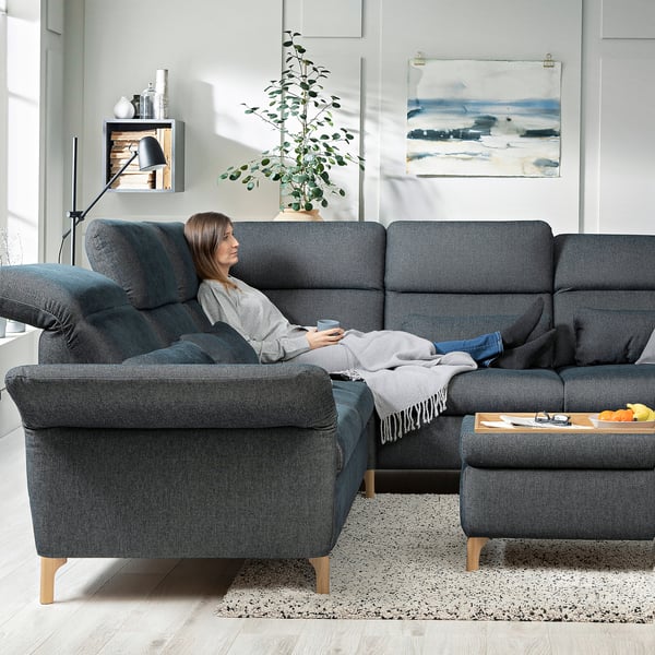 Person relaxing on grey FAMMARP sectional in modern living room.