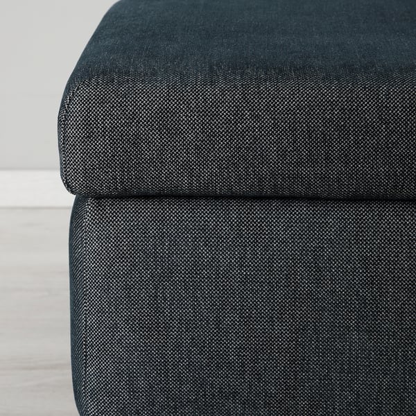 Close-up of dark cushioned ottoman, showcasing sturdy, high-quality fabric and plush comfort.