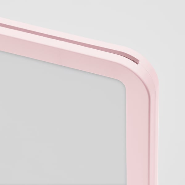 Close-up of pink plastic photo frame corner, smooth edges, modern design.
