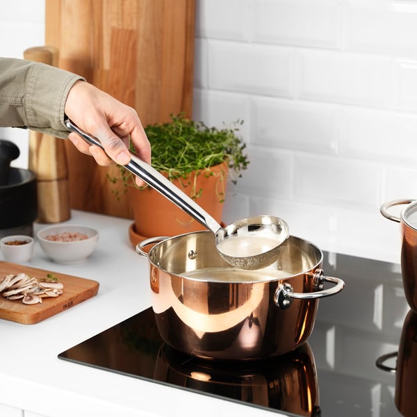 Stirring soup with FINMAT ladle.