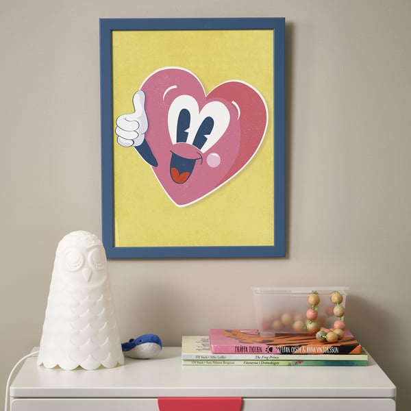 Colourful framed heart lamp on wall.