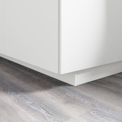 White cabinet base with plinth covering floor gap, part of IKEAs metod series.