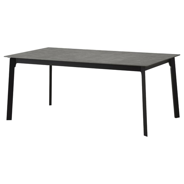 Extendable dining table, sleek design, al. Legs, stone top, seats 6-8.