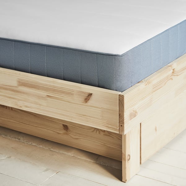 GLAMBERGET bed in light wood with blue-grey mattress, showing corner detail.