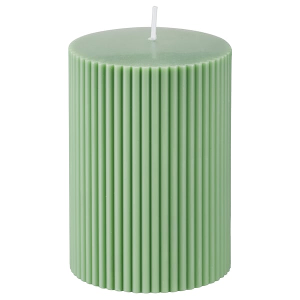 Green cylindrical candle; ribbed design; wax blend; cotton wick; decorative home accent.