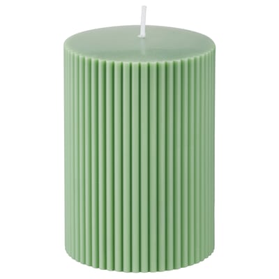 Green cylindrical candle; ribbed design; wax blend; cotton wick; decorative home accent.
