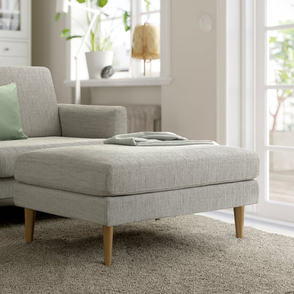 Mid-century GRILLSTORP sofa in tweed, light grey footstool, plants, lamp.