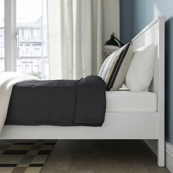 Modern bed with sturdy wooden legs and ample under-bed storage.