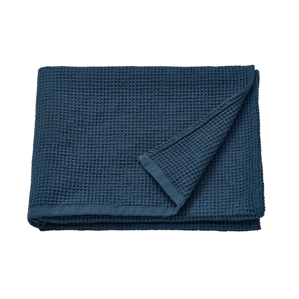 A folded dark blue GULLDYNA towel, 100% cotton, neatly stacked, showcasing a textured design.
