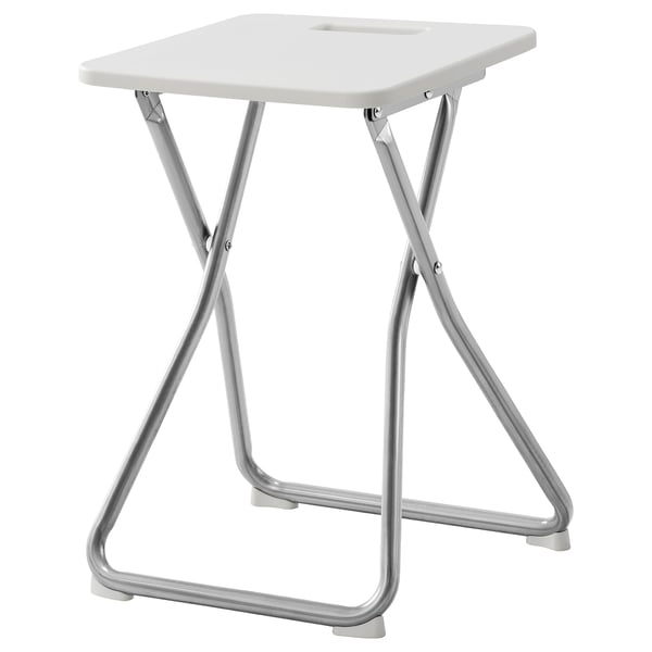 A GUNDE white folding stool with metal legs. Its compact and easy to store, designed for small spaces.