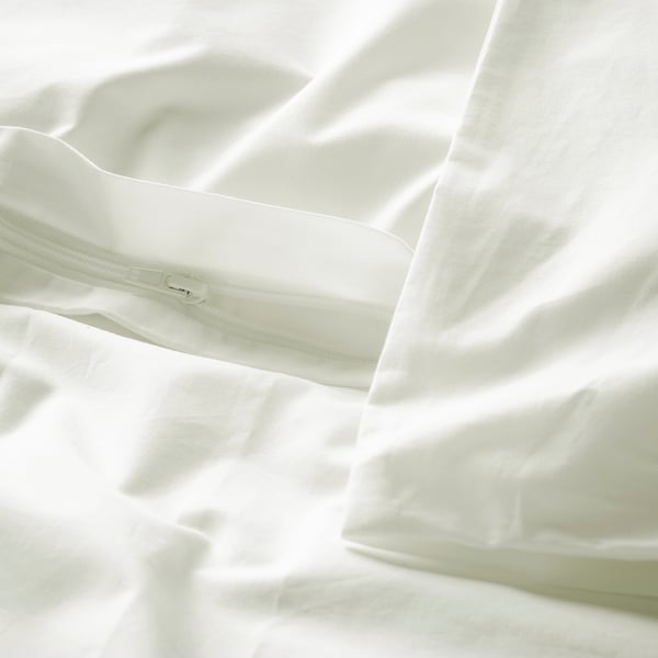 Close-up of white cotton duvet cover, showing zip closure detail. Crisp, percale weave, its durable and cools.
