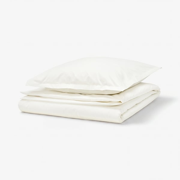 Crisp white cotton duvet set, neatly folded with zip and flange details.