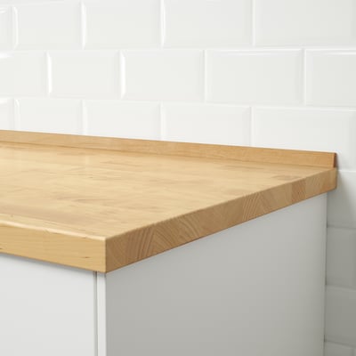 Wooden seal in tiled wall prevents water.
