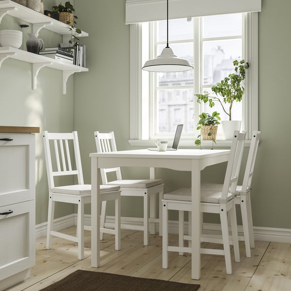 Small, white HAUGA dining set with square table and slatted chairs for four, perfect for cosy kitchens or living rooms.