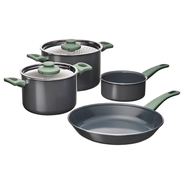 A set of grey HEMLAGAD pots and pans with green handles and lids, arranged in a group.