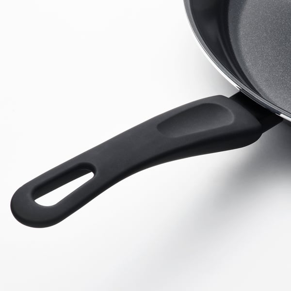 Black frying pan with an ergonomic handle and non-stick coating. Heat-resistant and easy to grip.