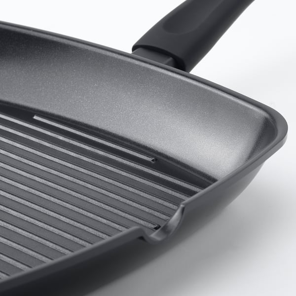 Close-up of modern, high-quality grill pan with non-stick coating, even heating base, and comfortable handles.